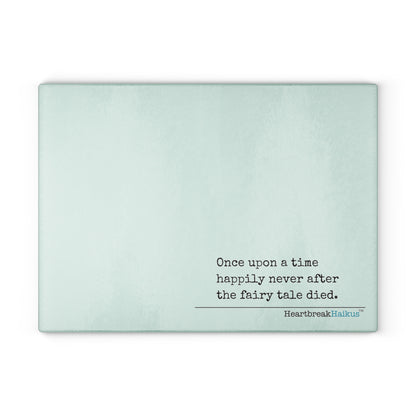 This cutting board features an original Heartbreak Haiku, perfect for adding a touch of creativity to your kitchen. The durable tempered glass material makes it a versatile preparation surface, while the vibrant colors and unique decoration process ensure