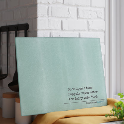 This cutting board features an original Heartbreak Haiku, perfect for adding a touch of creativity to your kitchen. The durable tempered glass material makes it a versatile preparation surface, while the vibrant colors and unique decoration process ensure